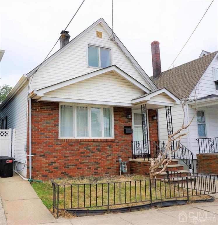 559 Johnstone Street Perth Amboy, NJ 08861 - Photo 1 of 24 a front view of a house with a yard