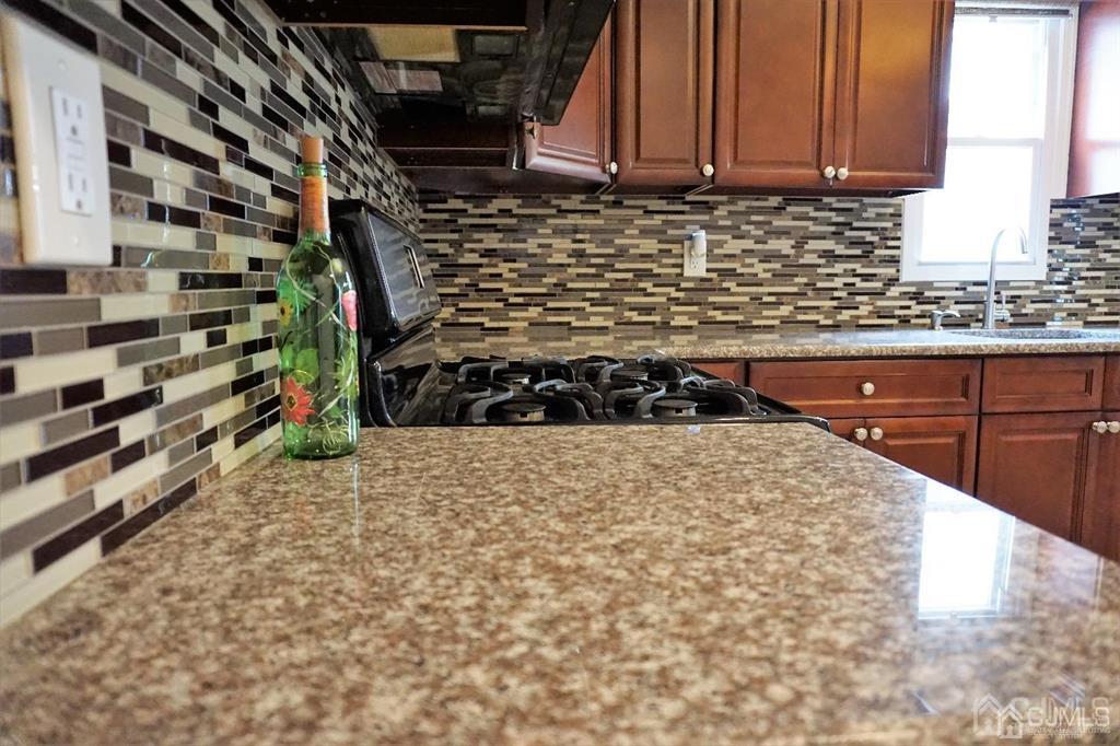 559 Johnstone Street Perth Amboy, NJ 08861 - Photo 12 of 24 a kitchen with a stove and a refrigerator