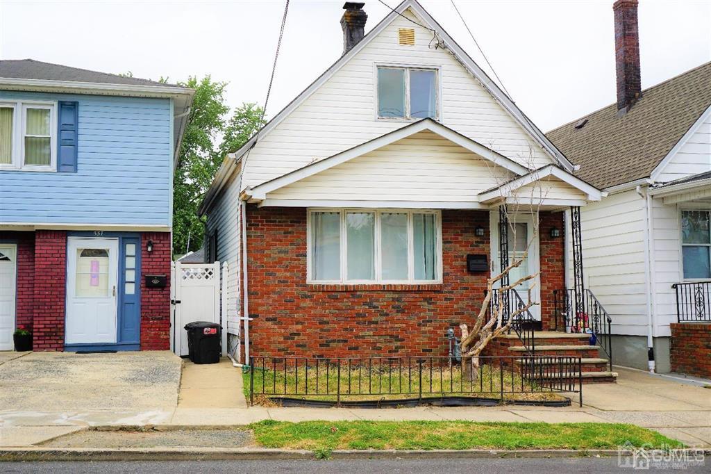 559 Johnstone Street Perth Amboy, NJ 08861 - Photo 2 of 24 a view of a brick house with large windows