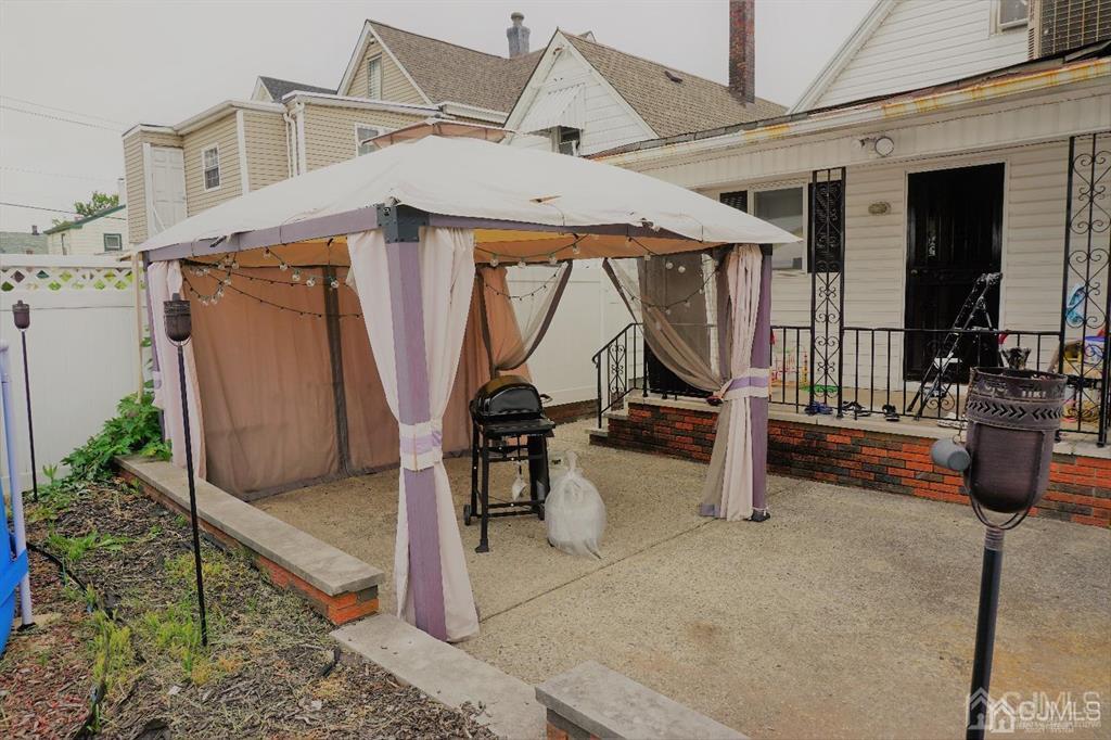 559 Johnstone Street Perth Amboy, NJ 08861 - Photo 22 of 24 a view of a house with backyard and porch