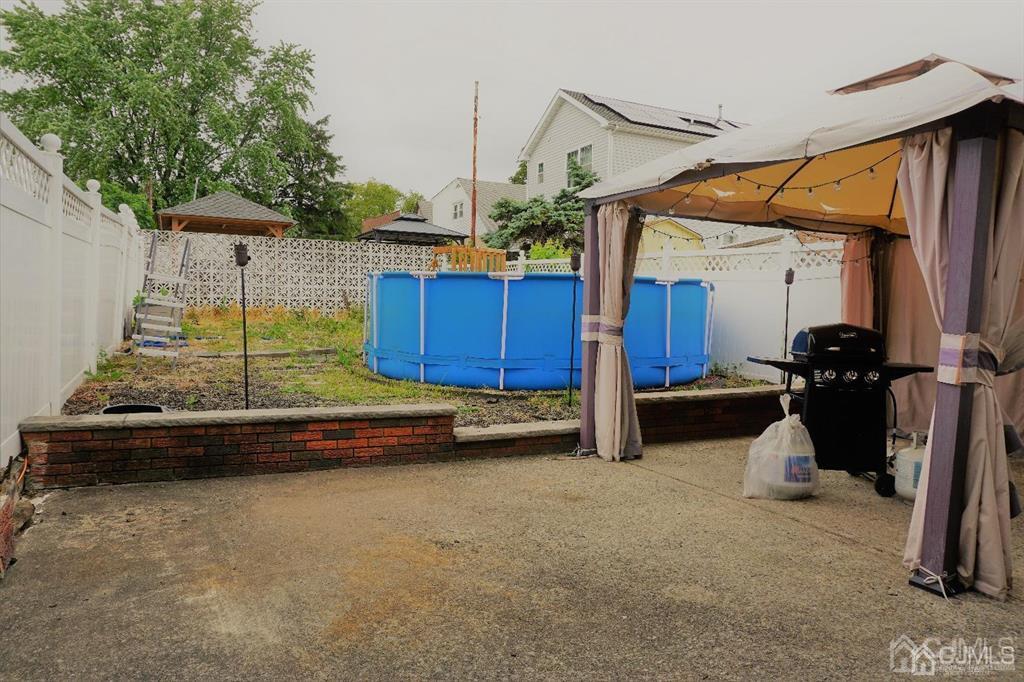 559 Johnstone Street Perth Amboy, NJ 08861 - Photo 24 of 24 a view of a house with backyard and wooden fence