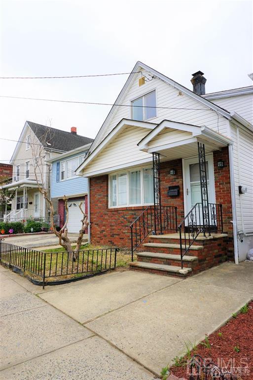 559 Johnstone Street Perth Amboy, NJ 08861 - Photo 3 of 24 front view of a house with a porch