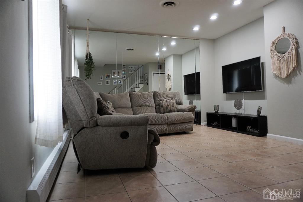 559 Johnstone Street Perth Amboy, NJ 08861 - Photo 5 of 24 a living room with furniture and a flat screen tv