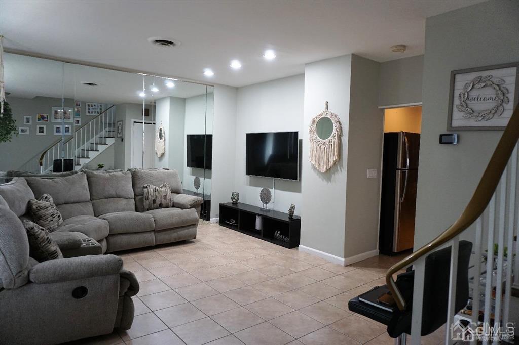 559 Johnstone Street Perth Amboy, NJ 08861 - Photo 6 of 24 a living room with furniture and a flat screen tv