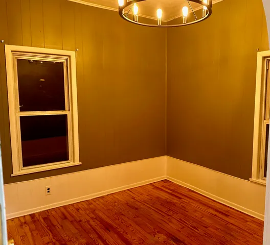 a view of a room with wooden floor