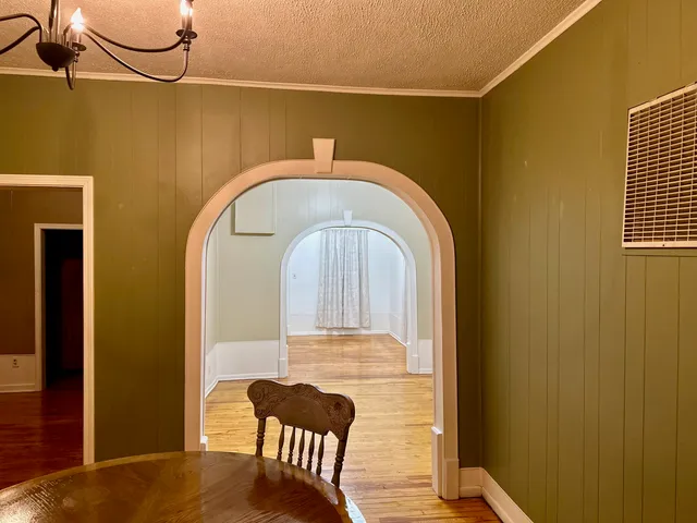 a view of a room with shelves and wooden table