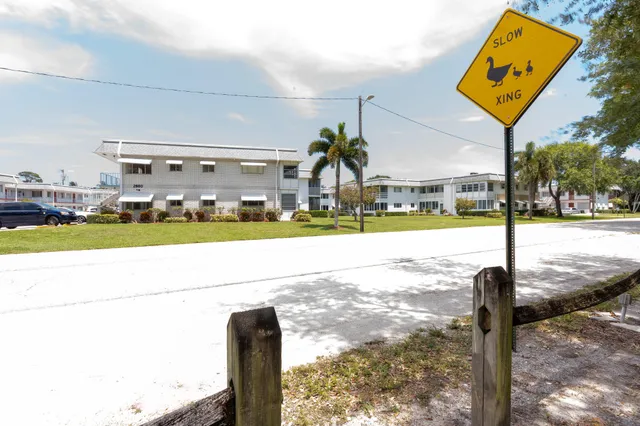 a street sign on a sidewalk next to a road