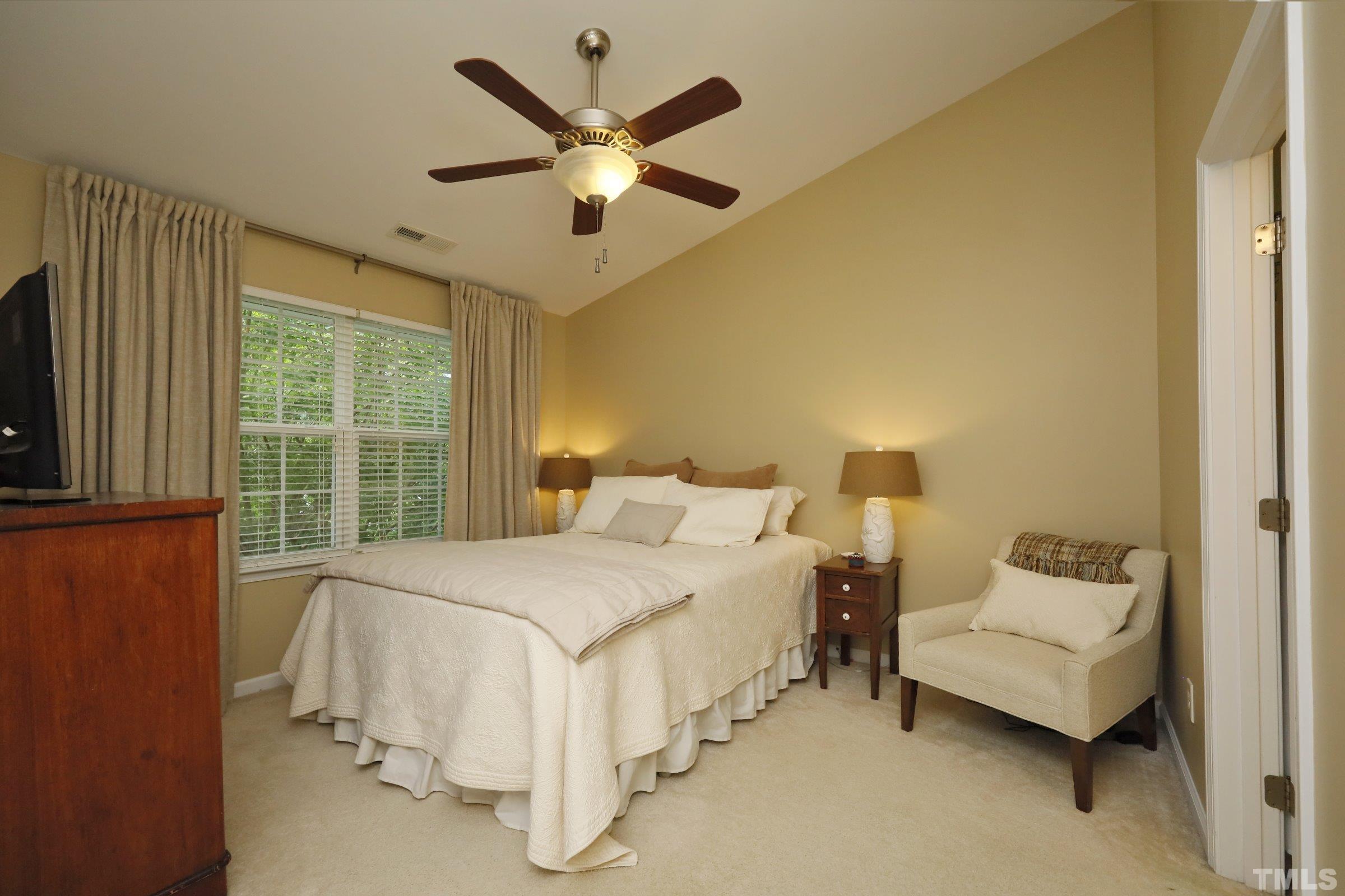 304 Red Elm Drive Durham, NC 27713 - Photo 16 of 27 a bedroom with a bed chandelier and a window