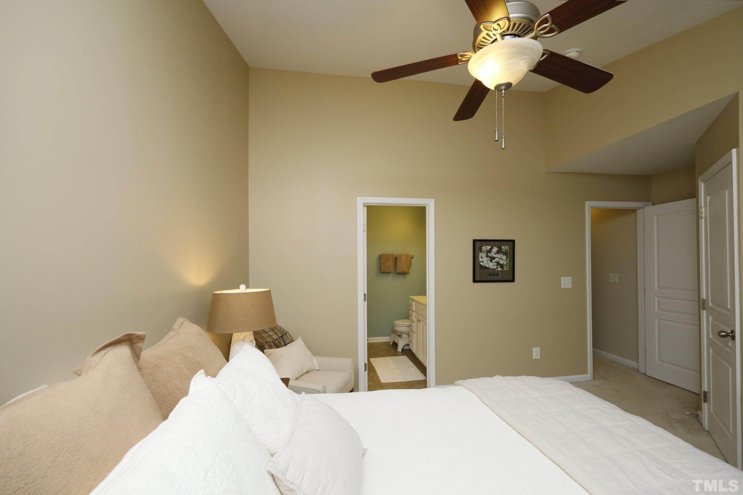 304 Red Elm Drive Durham, NC 27713 - Photo 17 of 27 a bedroom with a bed and a chandelier
