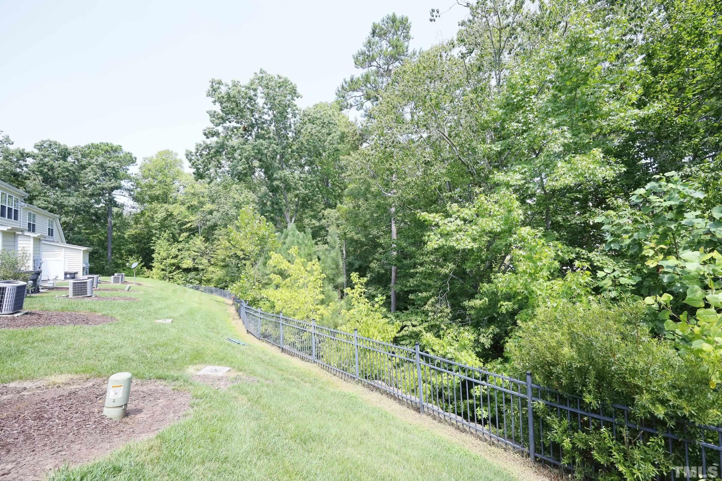 304 Red Elm Drive Durham, NC 27713 - Photo 27 of 27 a view of a yard with plants and a bench