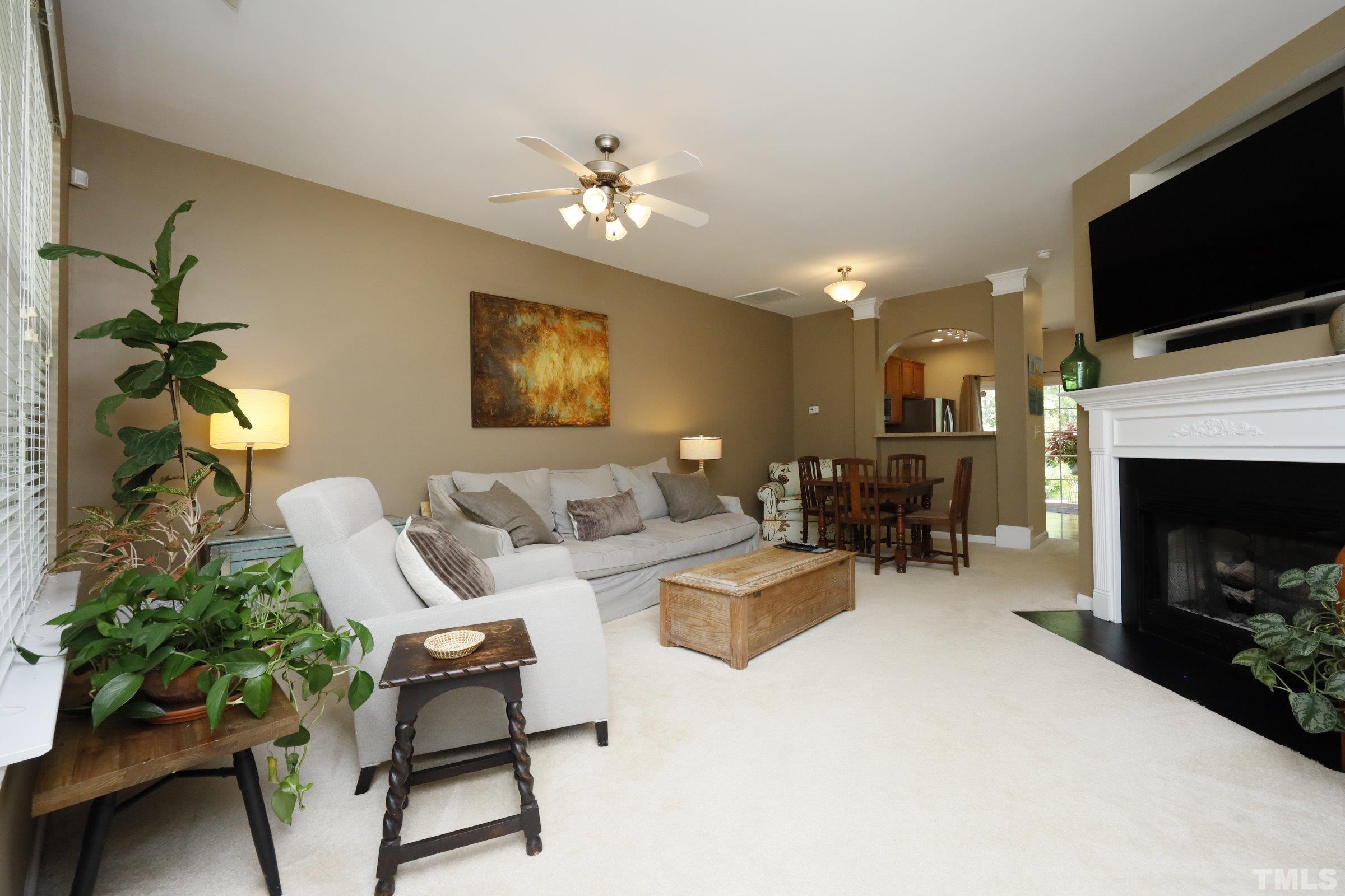 304 Red Elm Drive Durham, NC 27713 - Photo 6 of 27 a living room with furniture a flat screen tv and a fireplace