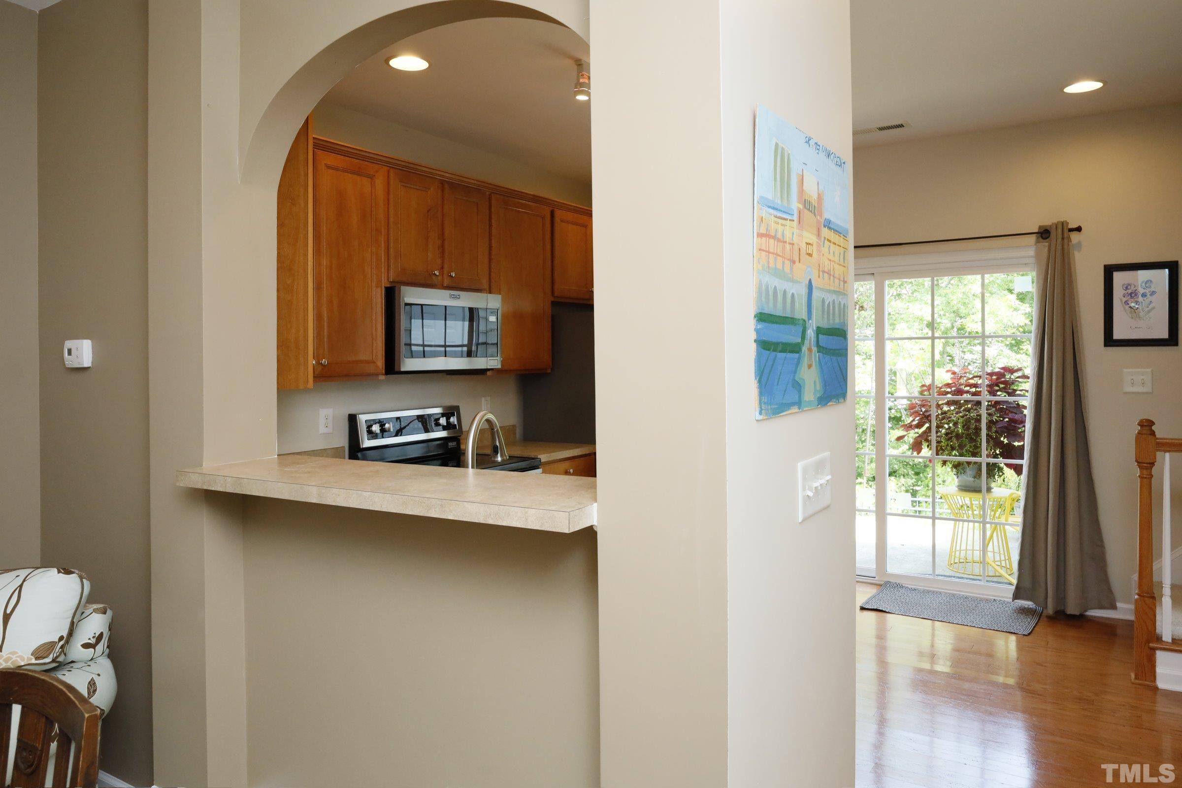 304 Red Elm Drive Durham, NC 27713 - Photo 9 of 27 a view of a hallway with wooden floor and a bathroom