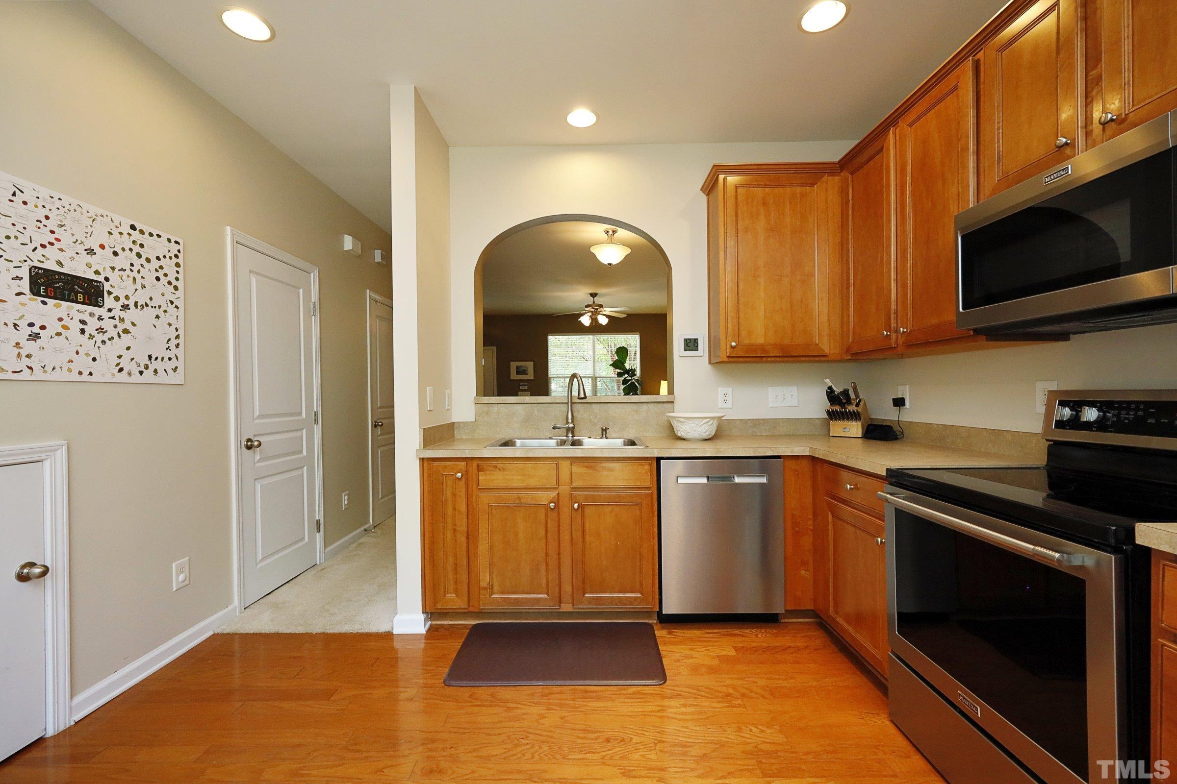304 Red Elm Drive Durham, NC 27713 - Photo 10 of 27 a kitchen with stainless steel appliances granite countertop a stove a sink and a microwave