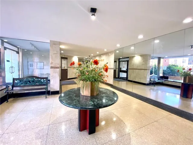 a kitchen with stainless steel appliances kitchen island granite countertop a table and chairs in it
