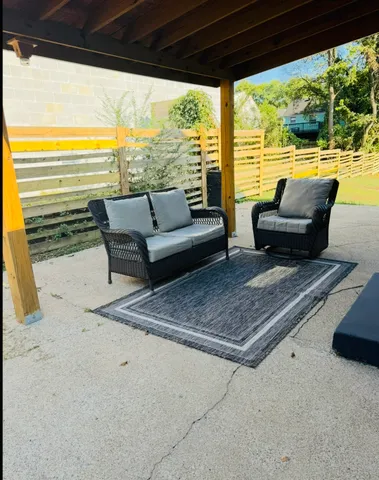 a living room with furniture and floor to ceiling windows