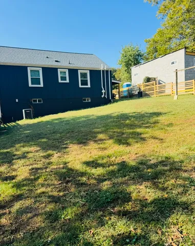 a front view of house with yard and trees
