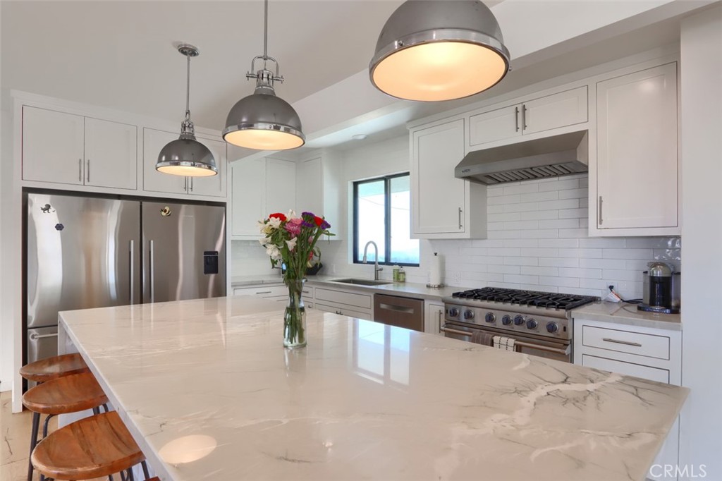 5076-5076 Allred Road Mariposa, CA 95338 - Photo 16 of 75 a kitchen with stainless steel appliances granite countertop a stove a refrigerator a sink a oven with a dining table and chairs