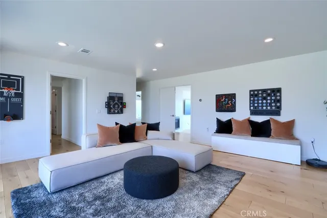 a bedroom with a bed and a potted plant