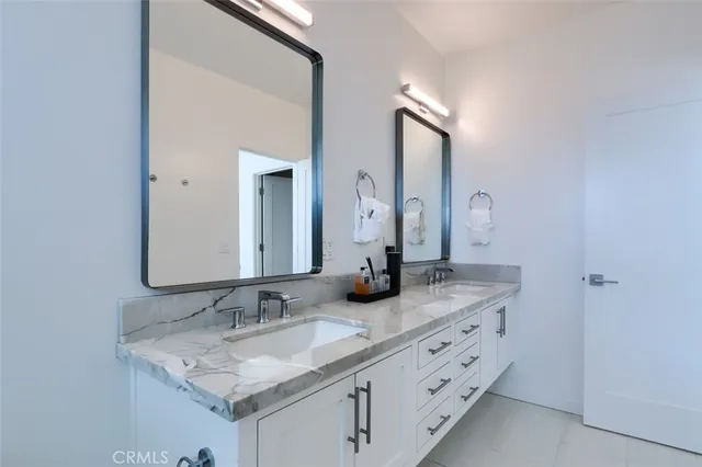 a bedroom with furniture and a flat screen tv