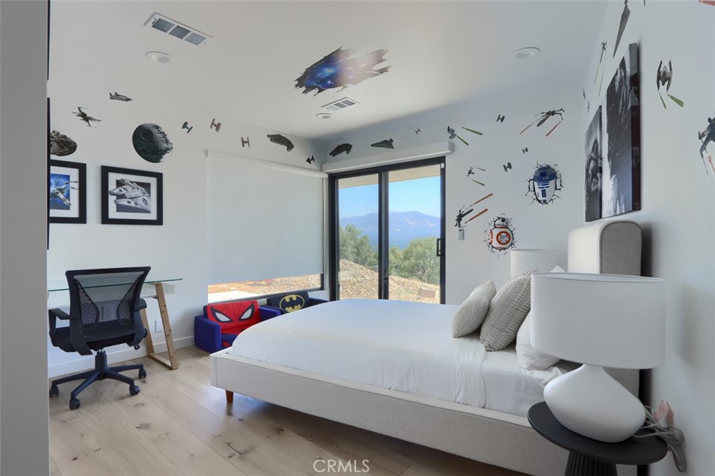 5076-5076 Allred Road Mariposa, CA 95338 - Photo 47 of 75 a bedroom with a bed and a chair