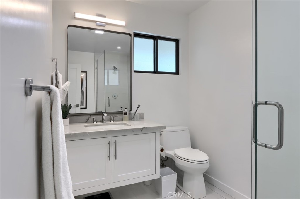 5076-5076 Allred Road Mariposa, CA 95338 - Photo 55 of 75 a bathroom with a toilet sink vanity and mirror