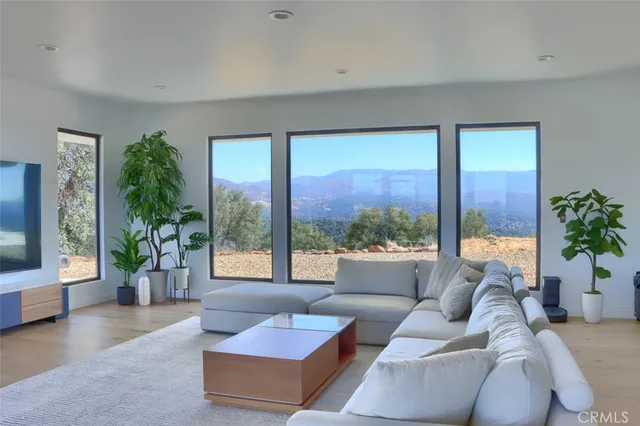 a kitchen with white cabinets and a window