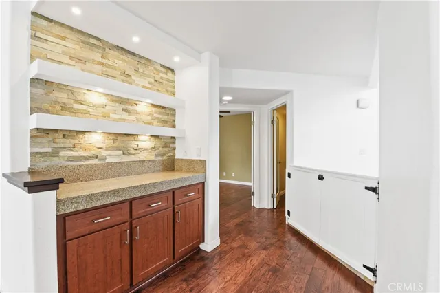 a spacious bathroom with a granite countertop sink and a mirror