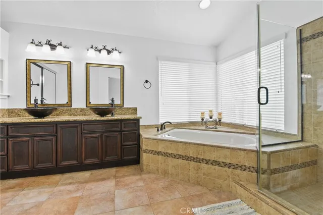 a spacious bathroom with a granite countertop sink and a mirror
