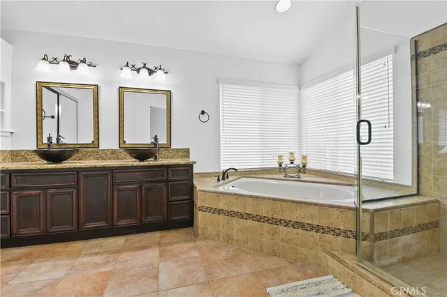 a spacious bathroom with a granite countertop sink and a mirror