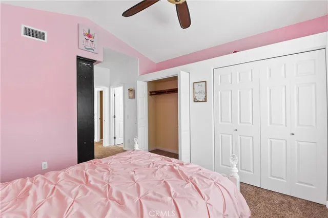 a bedroom with a bed and a closet