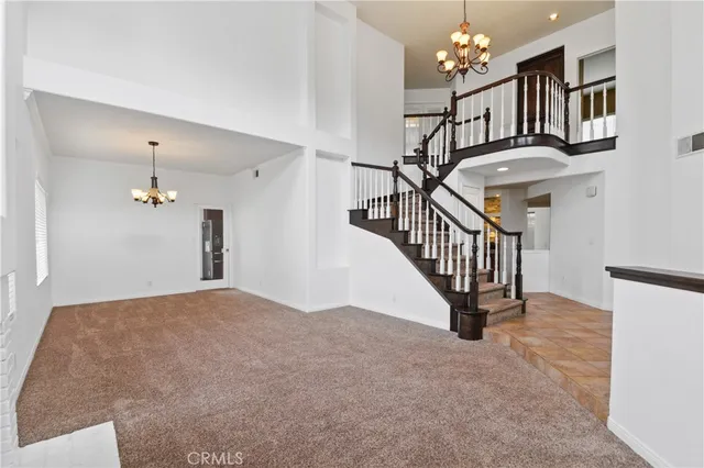 a view of entryway and hall with a chandelier