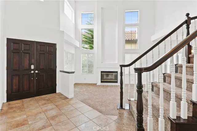 a bedroom with wooden floor and windows