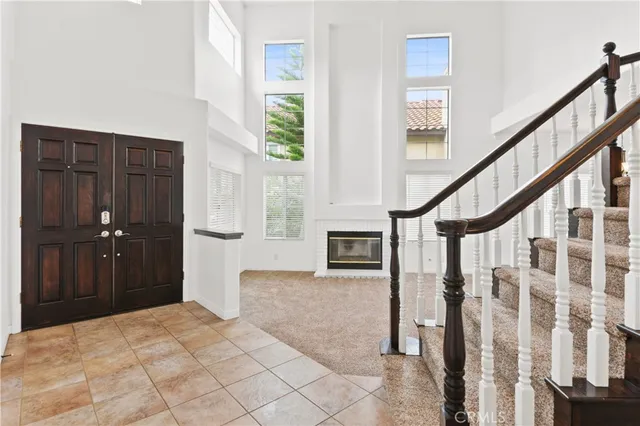 a bedroom with wooden floor and windows
