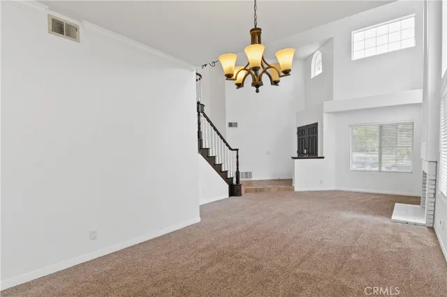 a view of a livingroom with a window and a chandelier