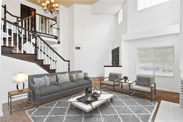 a living room with furniture a rug and a window