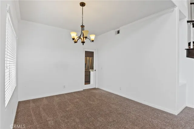 a view of a chandelier fan and a window