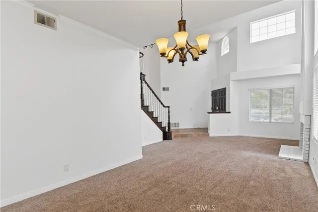 a view of a livingroom with a window and a chandelier