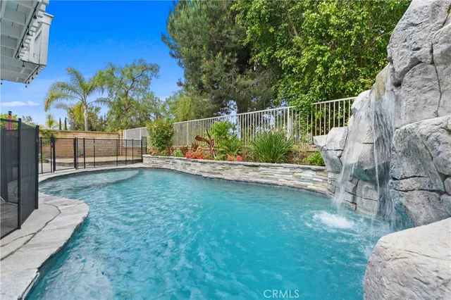 a view of a garden with wooden fence