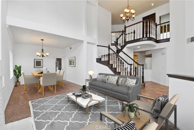 a living room with furniture chandelier and a table