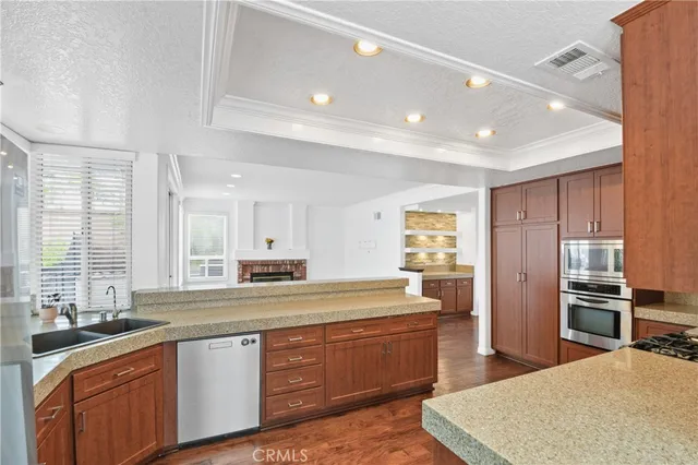 a kitchen with stainless steel appliances a sink stove and refrigerator