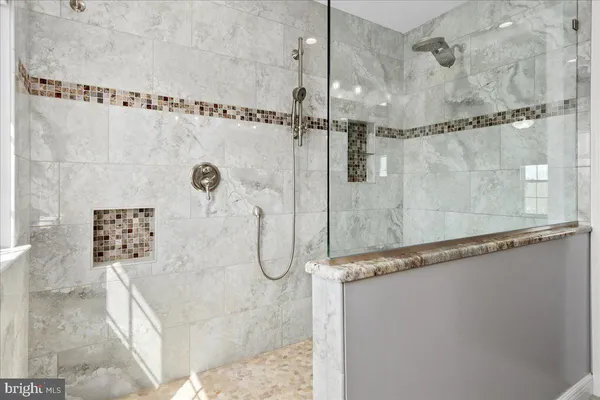 a bathroom with a bathtub and shower