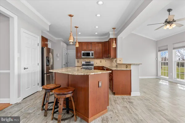 a white refrigerator freezer and a stove sitting inside of a kitchen