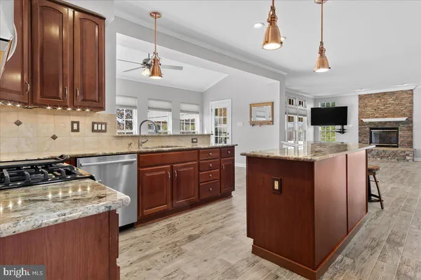a room with a large window and a kitchen view