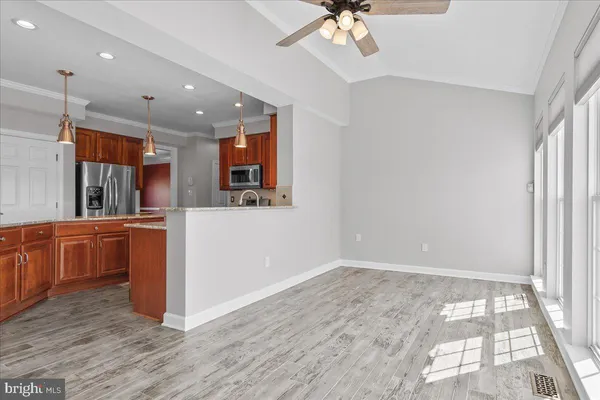 wooden floor fireplace and windows in an empty room
