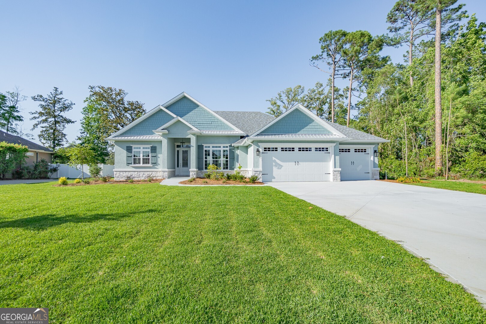 a front view of a house with a garden