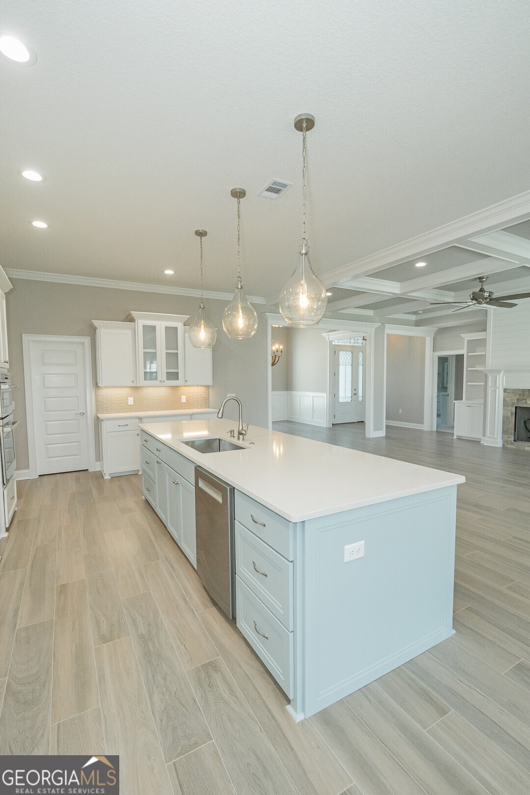 205 Riley Hunter Drive Kingsland, GA 31548 - Photo 12 of 81 a large kitchen with kitchen island a stove a sink a center island and wooden floor