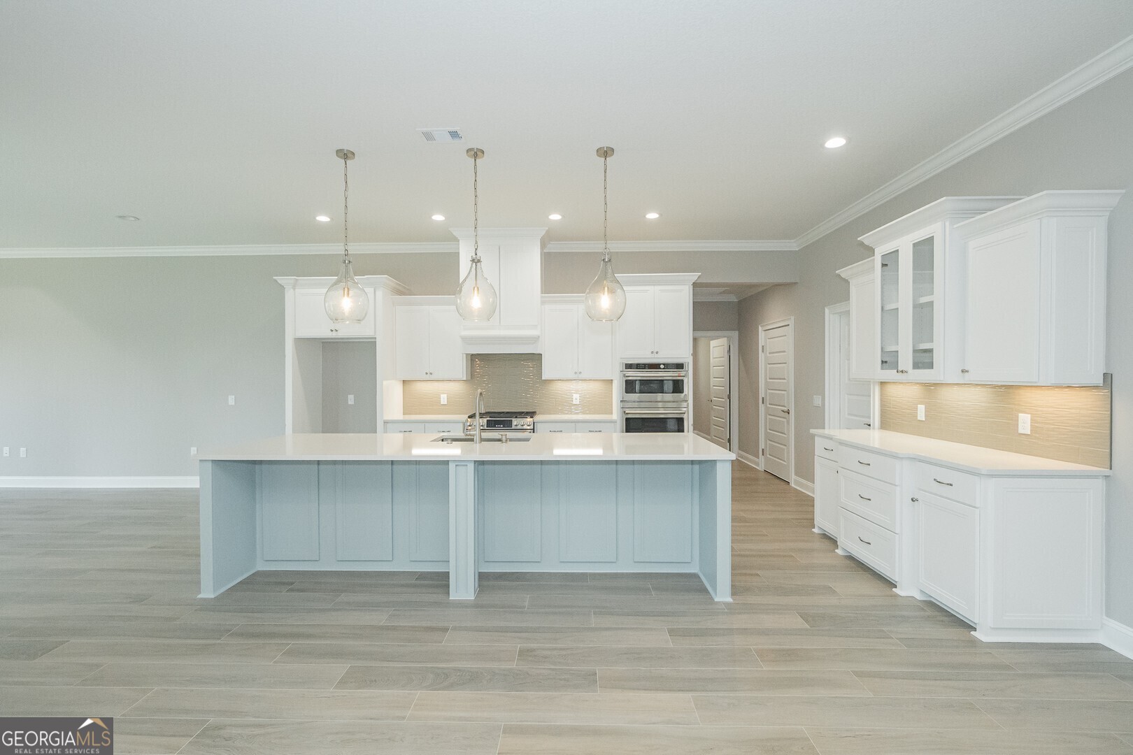 205 Riley Hunter Drive Kingsland, GA 31548 - Photo 6 of 81 a large kitchen with stainless steel appliances a large counter top a stove a sink dishwasher and a refrigerator
