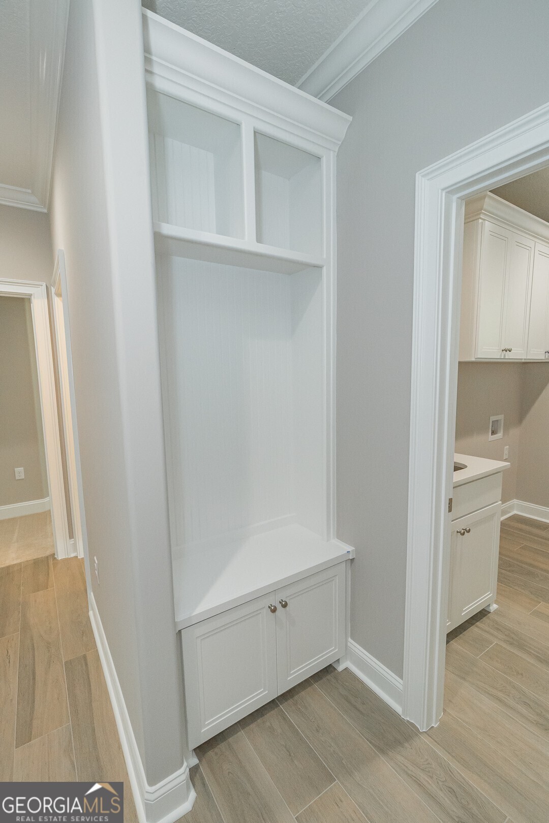 205 Riley Hunter Drive Kingsland, GA 31548 - Photo 65 of 81 a view of an empty walk in closet with wooden floor and a bathroom