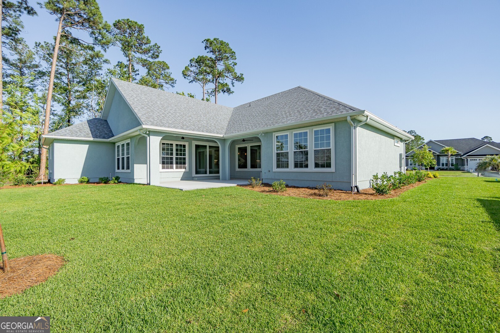 205 Riley Hunter Drive Kingsland, GA 31548 - Photo 77 of 81 a view of a house with a backyard and a patio