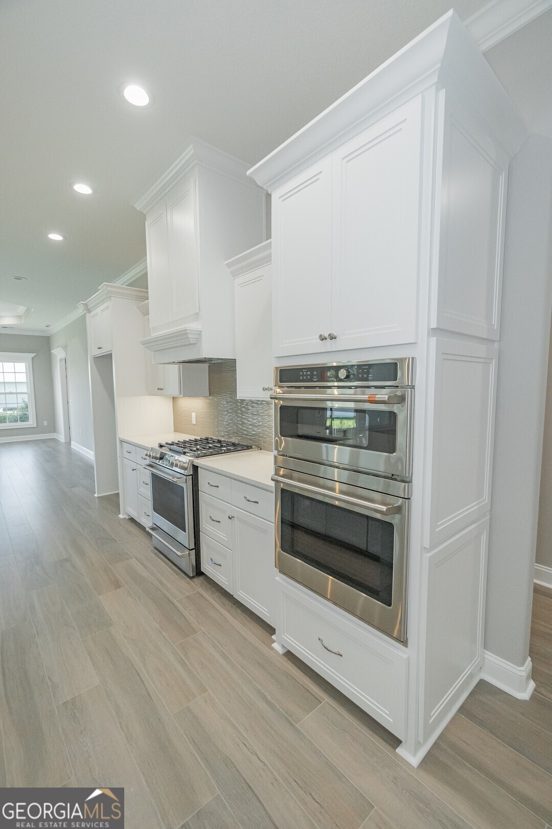 205 Riley Hunter Drive Kingsland, GA 31548 - Photo 10 of 81 a kitchen with granite countertop a stove and cabinets